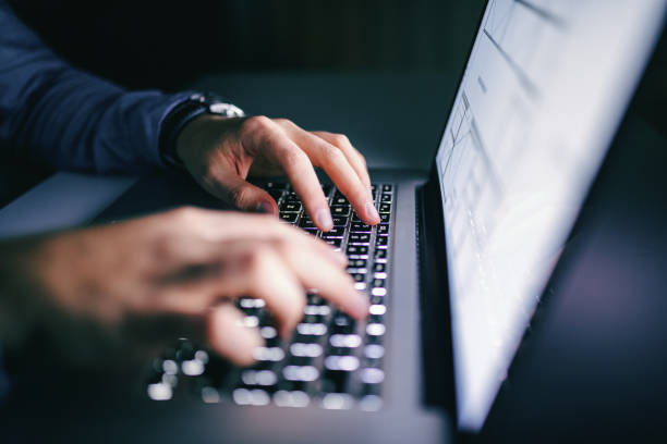 Person typing on a laptop, focusing on the development of online business in the UAE.