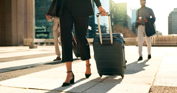 Professionals walk with luggage, symbolizing business travel and foreign investment in the Emirates.