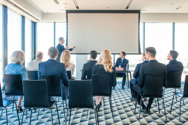 A business seminar in a modern conference room, discussing strategies to save on licensing costs in RAK Free Zone.